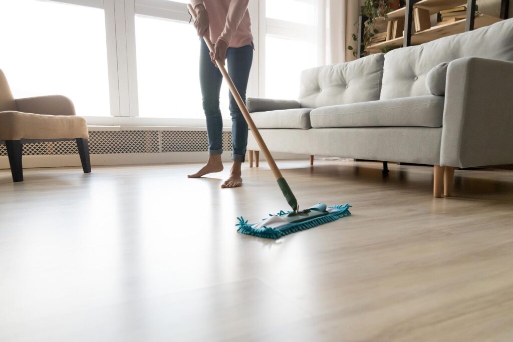 Person mopping wooden floor